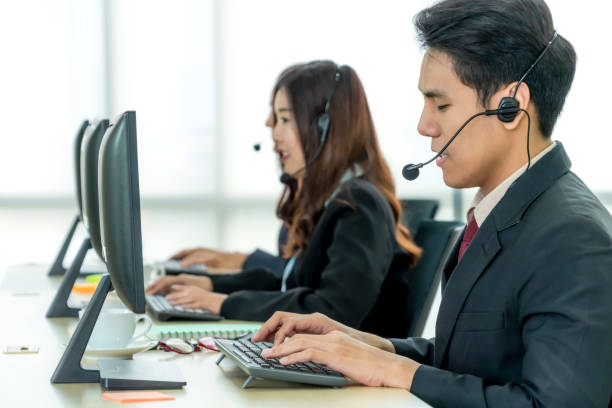 istock Business people wearing headset working in office 1263536058