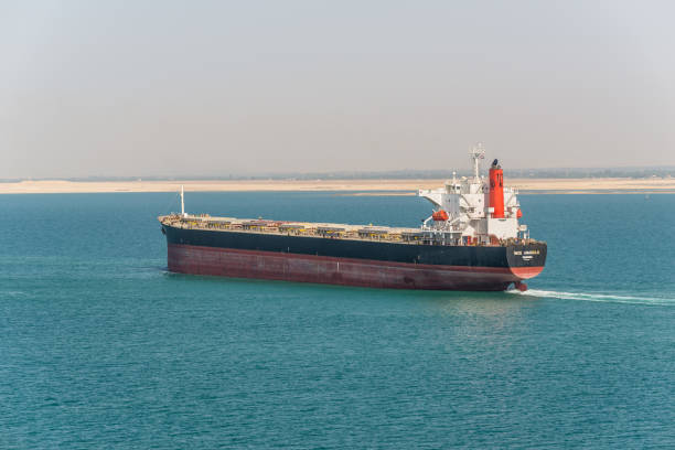 Suez, Egypt - November 14, 2019: Bulk carrier vessel Ince Anadolu passing Suez Canal in Egypt. The Suez Canal is an artificial sea-level waterway, connecting Mediterranean Sea to Red Sea.