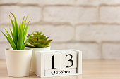 October 13 on a wooden calendar on a table or shelf.One day of the autumn month.Calendar for October. Autumn