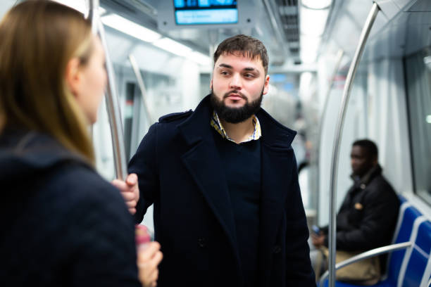 istock Young man talking with woman in subway 1263540857
