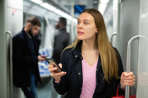 istock Girl using mobile phone in metro car 1263540871