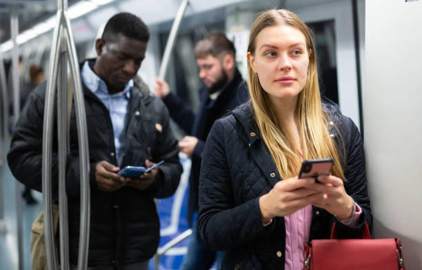 istock Girl using mobile phone in metro car 1263540877