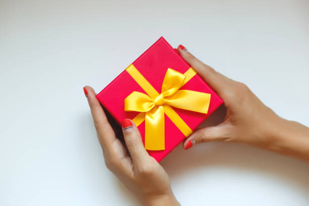 istock female hands with beautiful manicure hold a gift box 1263542262