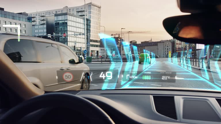 Futuristic Autonomous Self-Driving Car Moving Through City, Head-up Display HUD Showing Infographics: Speed, Distance, Navigation. Road Scanning. Driver Seat Point of View POV / First Person View FPV