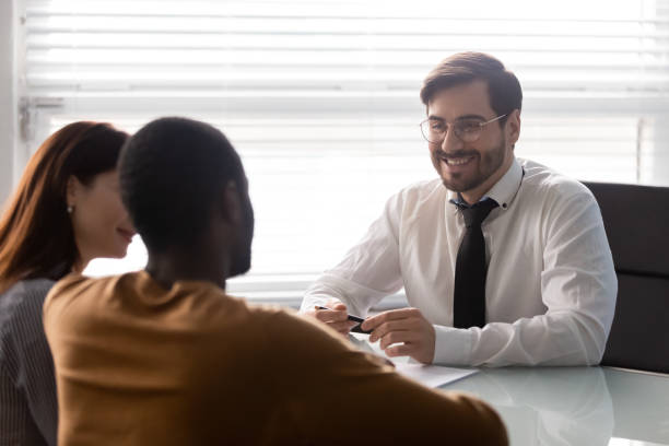istock Young smiling businessman with diverse customer at negotiation. 1263543066