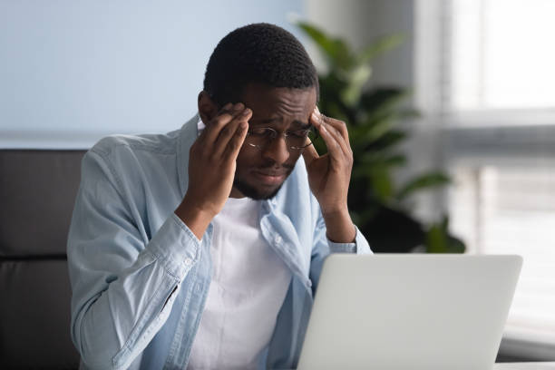 istock Unhappy african american businessman suffering from headache at work. 1263543117