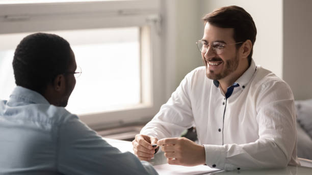 istock Happy candidate applicant talking with businessman at job interview. 1263543130