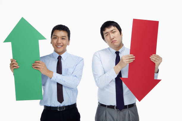 istock Two businessmen holding up an arrow 1263543282