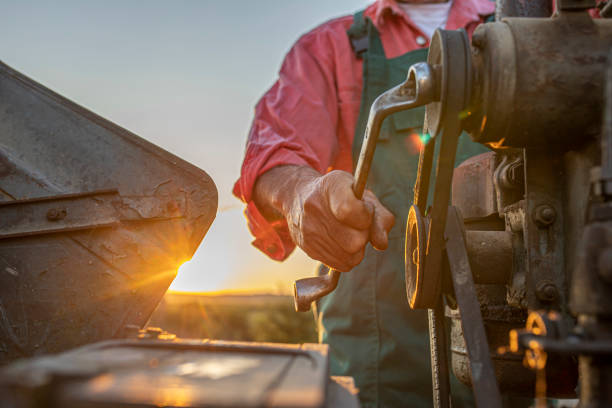 Farmer operating a tractor on a farm during sunset