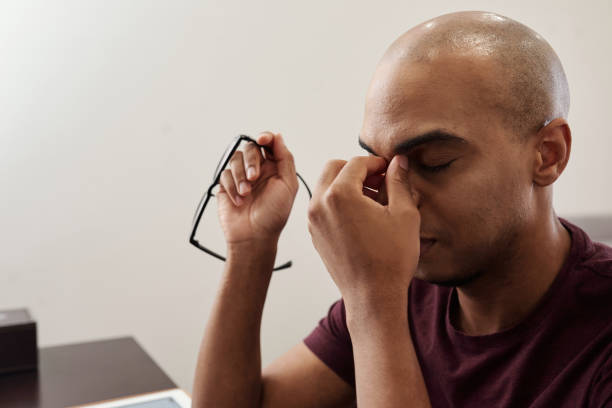istock Tired man taking off glasses 1263546071