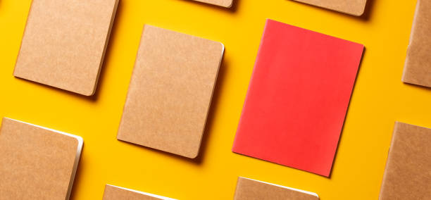 istock creativity content marketing concept,.top view of red notebook align in pattern on yellow table background.mockup for advertise content online.unique idea 1263547013