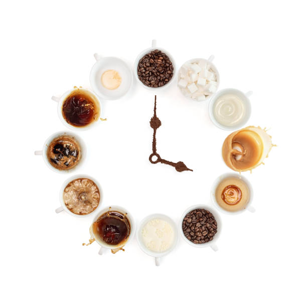 Clock made with cups of coffee and beans as lancets on white background stock photo