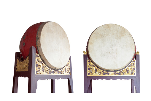 Traditional Chinese big drums on wooden frame with dragon relief isolated on the white background, this traditional drums were usually pounded  in sacrificial rites or festivals in ancient times
