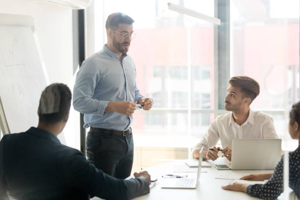 istock Business coach giving presentation to young team 1263550192