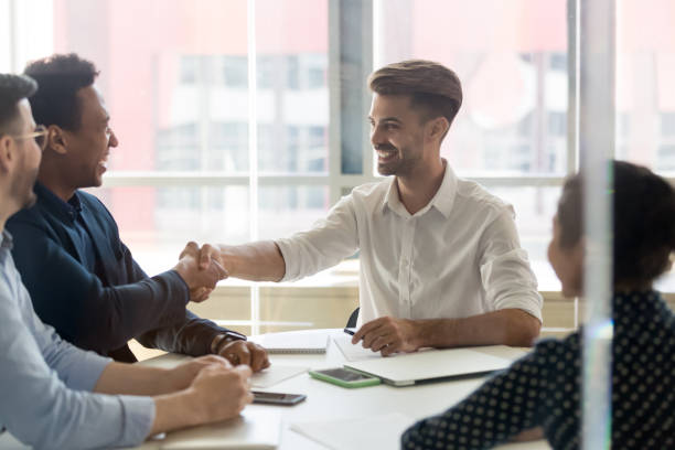 istock Young positive businessmen handshaking greeting each other 1263550217