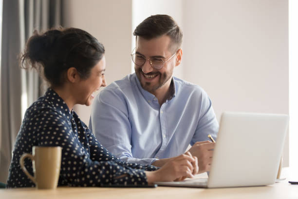 istock Laughing successful multiracial business couple in office 1263550229