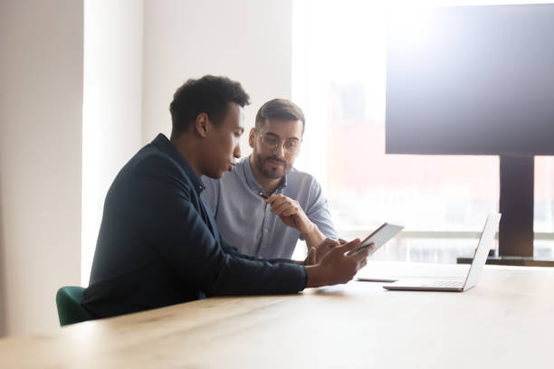 istock Black male leader working together with partner at office 1263550241