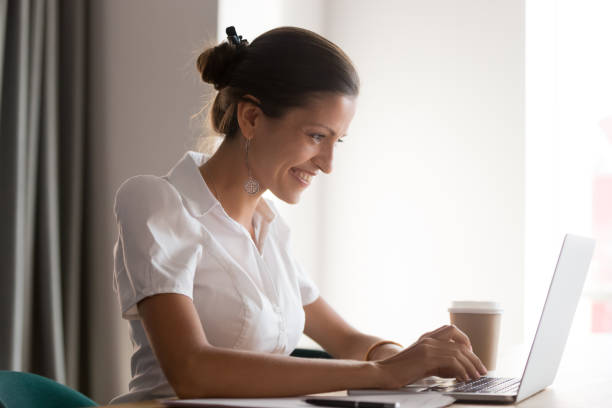 istock Smiling young businesswoman working on computer at office. 1263550277