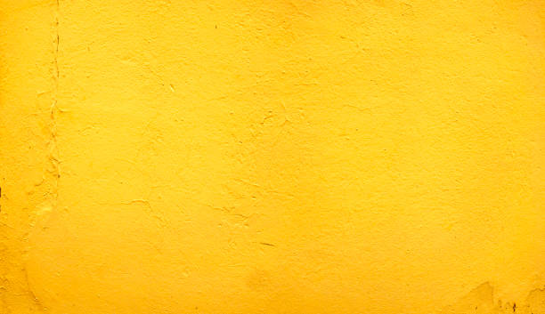 istock yellow cement wall with texture detail 1263550476
