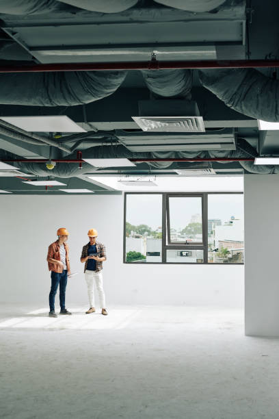 istock Contractors inspecting house rooms 1263550489
