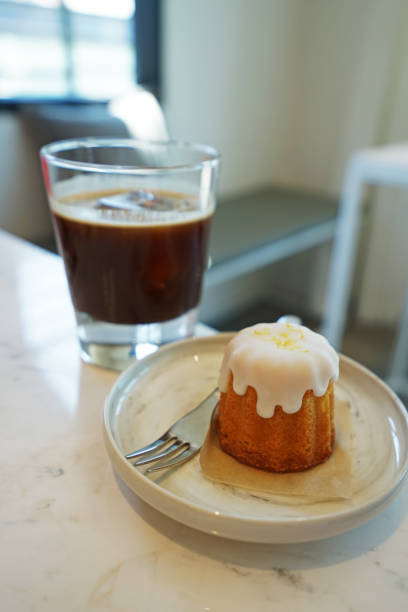 Lemon cake served with a glass of iced black coffee