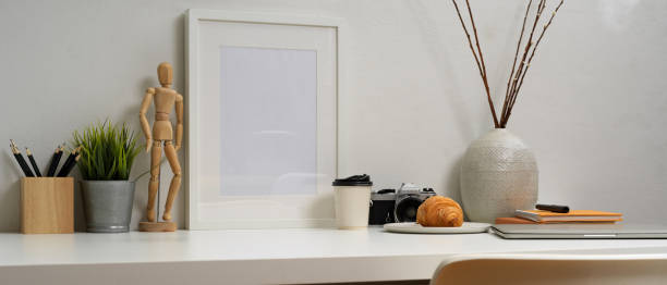 istock Worktable with stationery, camera, decorations, pastry and beverage on white table 1263551546