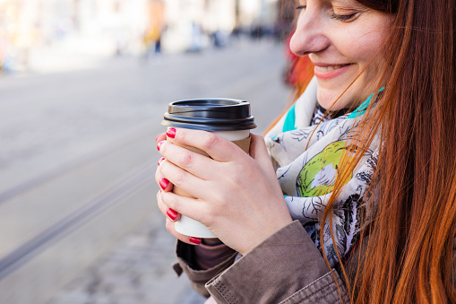 Woman hold coffee cup on the street