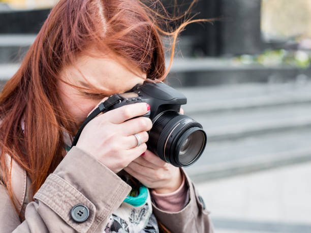 istock attractive young woman talking pictures outdoors. Sunny spring afternoon. 1263552044