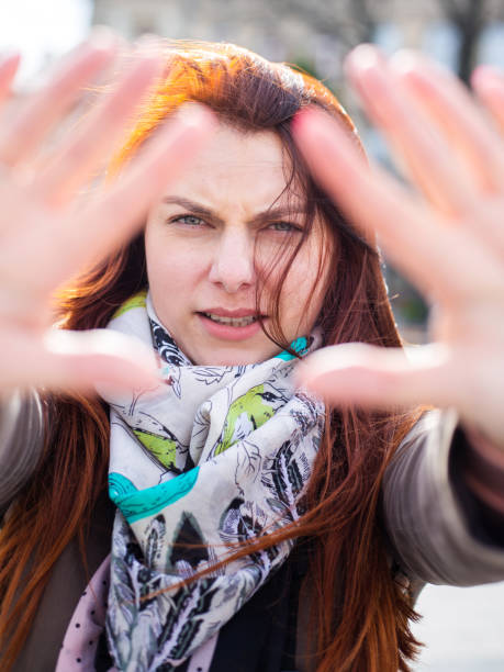 istock attractive redhead woman serious and determined, putting hand in front, stop gesture, deny concept 1263552063