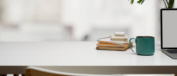 istock Workplace with copy space, book, mug, blank screen laptop and decoration in office room 1263552912