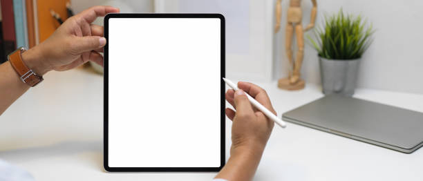 istock Male entrepreneur using tablet with clipping path on workspace in office room 1263552929