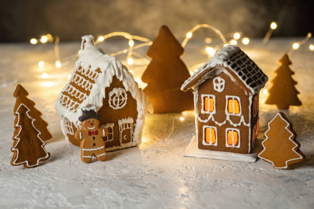 Decorated gingerbread houses christmas cookies on dark table stock photo