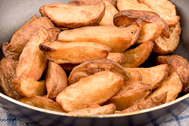 istock Macro shot. Frying pan with chips on a wooden table. 1263554948
