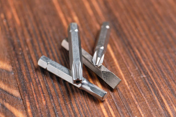 istock Various nozzles for a screwdriver lie on a wooden background 1263555090