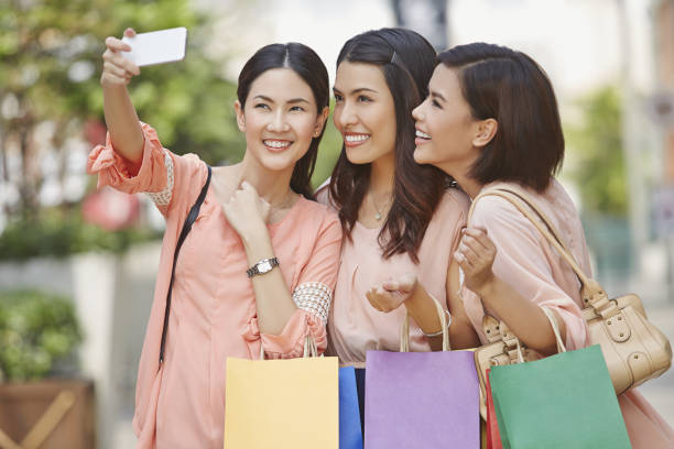 istock Young women taking photograph together 1263557407