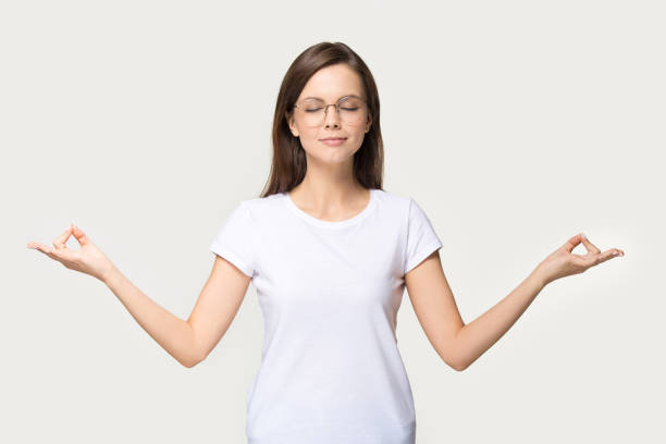 istock Focused young woman in glasses meditating in studio 1263557680