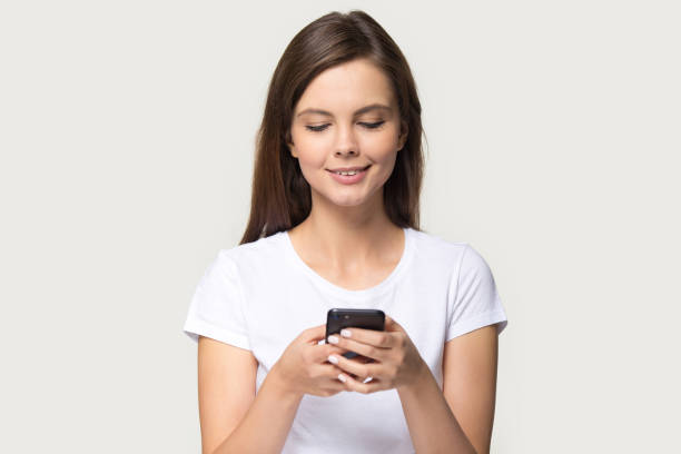 istock Smiling millennial girl using modern smartphone browsing internet 1263557693
