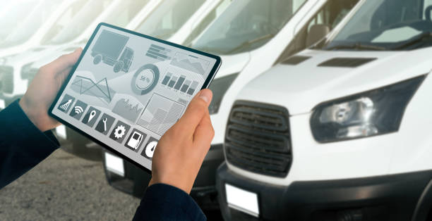 Fleet management Manager with a digital tablet on the background of trucks. Fleet management a fleet of vans stock pictures, royalty-free photos & images