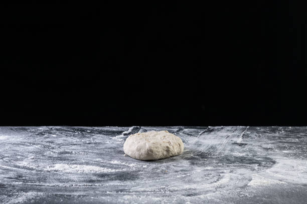 istock Pizza dough ball on dark background 1263559443