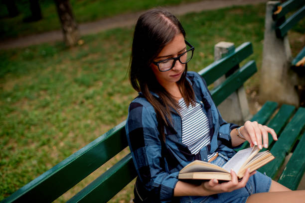 istock Young woman relaxing in nature with book 1263559532