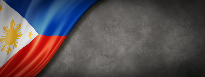 Philippines flag on concrete wall. Horizontal panoramic banner.