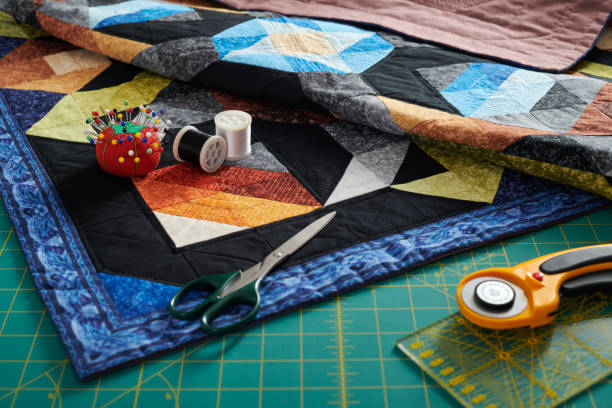 istock Small quilt, cutting mat and sewing and quilting accessories 1263565198