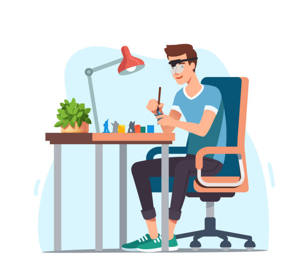 Young man enjoying miniature military figure model painting hobby. Hobbyist sitting at desk with lamp in magnifying glasses painting with brush carefully. Favorite pastime. Flat vector illustration Young man enjoying miniature military figure model painting hobby. Hobbyist sitting at desk with lamp in magnifying glasses painting with brush carefully. Favorite pastime. Flat style vector isolated illustration hobbyist stock illustrations