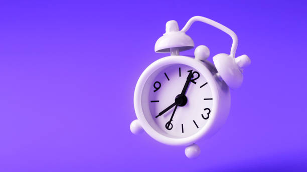 istock White retro style alarm clock in levitation isolated on purple background. 1263574060