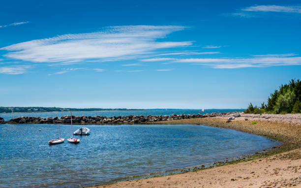 istock Seascape with moored dinghies at rocky shore on blue sky with white clouds backgrounds 1263575925
