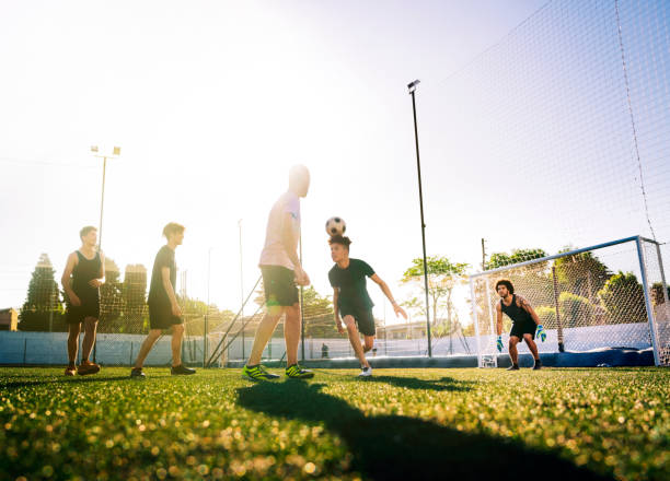 istock Player heading the ball in soccer ground 1263577064