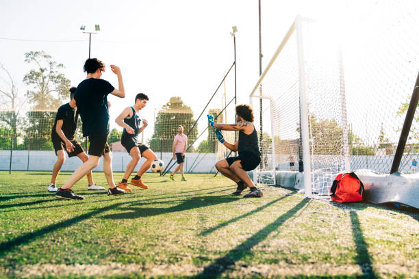 istock Players scoring goal in soccer ground 1263577082