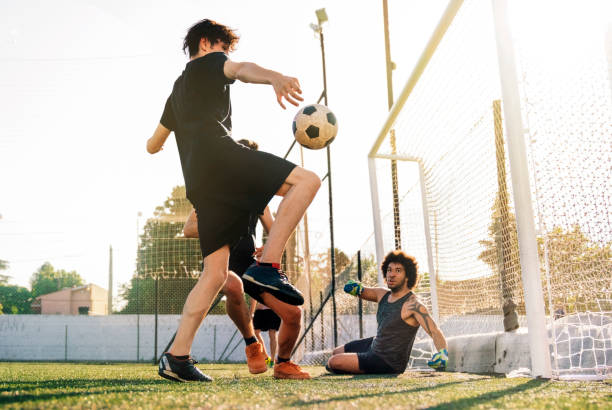 istock Male player scoring goal in soccer field 1263577103