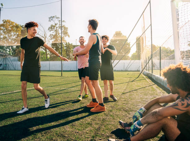 istock Smiling players talking in soccer field 1263577141