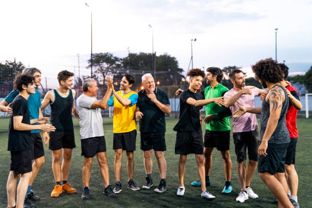 istock Smiling soccer team talking after game in field 1263577337